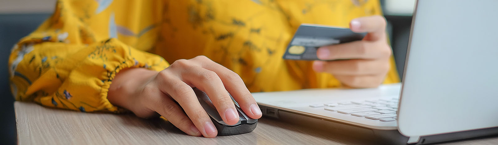 Woman using credit card to shop online