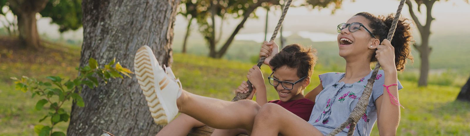 Siblings swinging