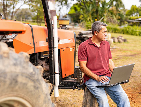 Farmer using a laptop computer at his agricultural business